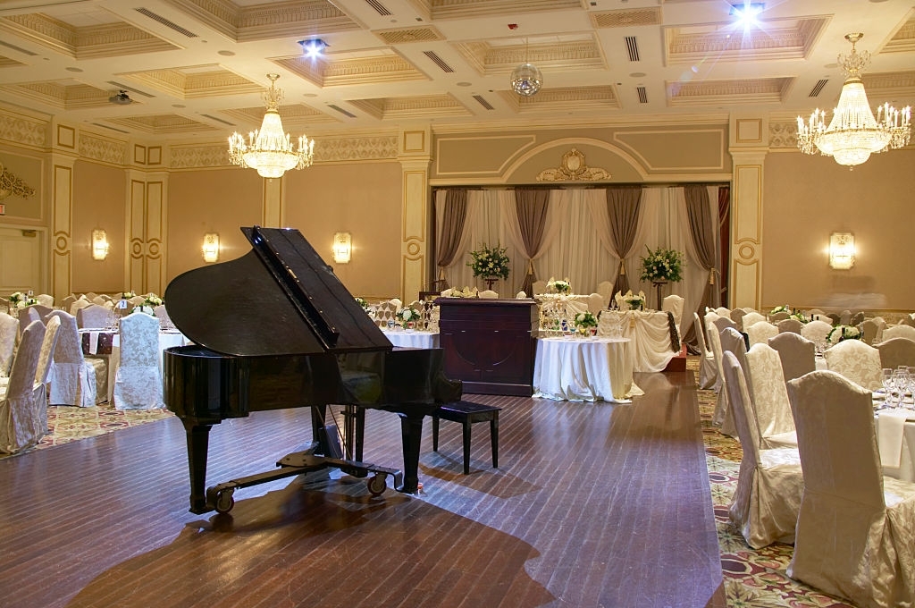 wedding hall with piano in middle and chairs in surrounding