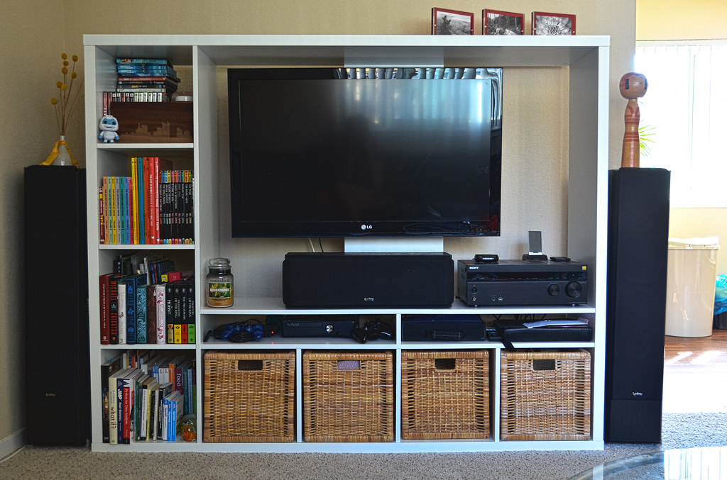 A huge Tv mounted near books 