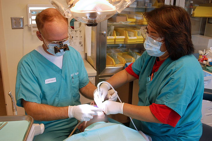 dentists performing dental surgery