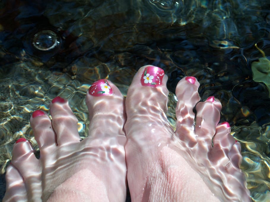 woman feet submerged in water 